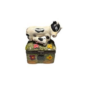 Hand-painted porcelain trinket box featuring a Holstein cow nursing a calf.